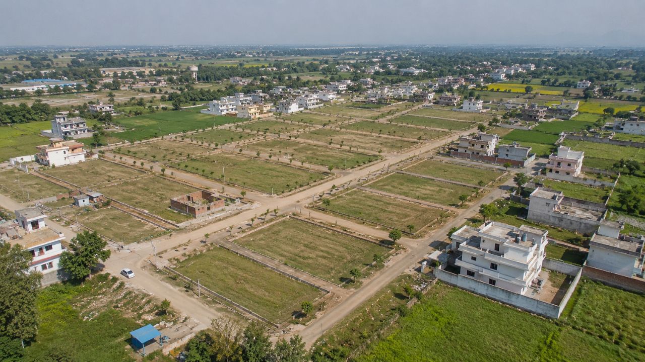 Aerial view of Bhurarani Rudrapur showing residential plots, developing colonies, internal roads, and surrounding agricultural land in Uttarakhand.