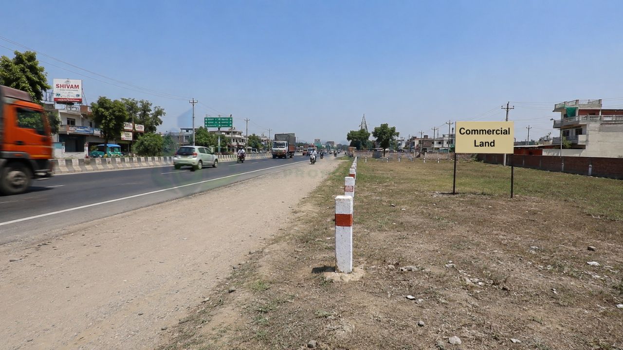 Commercial land along a major highway in Rudrapur, Uttarakhand, ideal for showrooms, warehouses, hotels, fuel stations, and commercial real estate development.