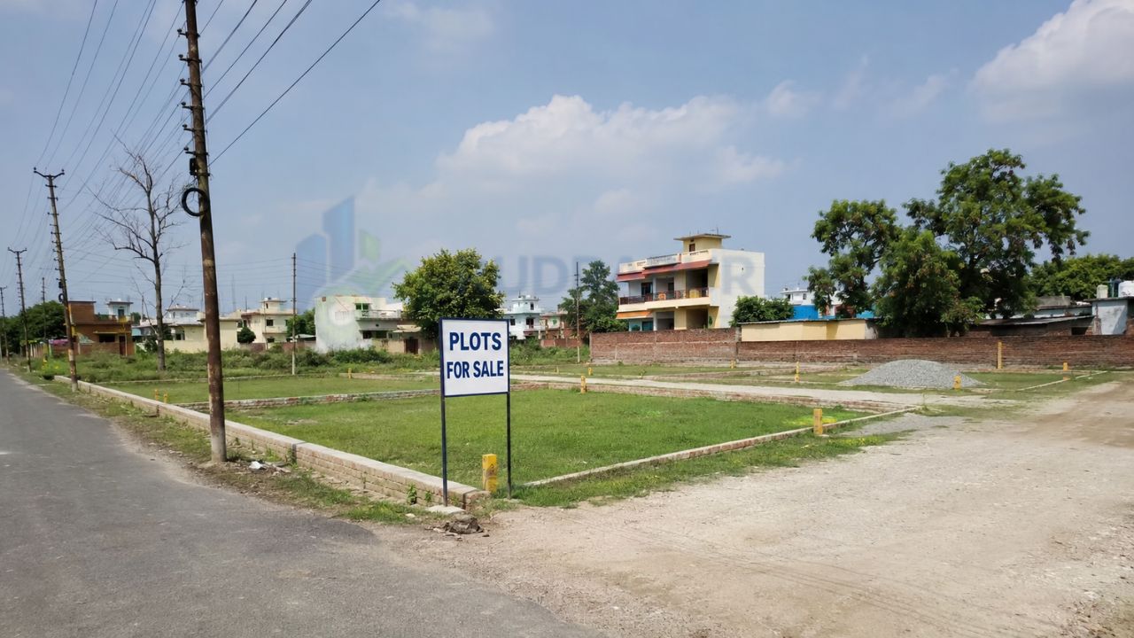 Residential plots for sale on Dineshpur Road in Rudrapur, Uttarakhand, with road access and a developing neighborhood suitable for home construction and investment.