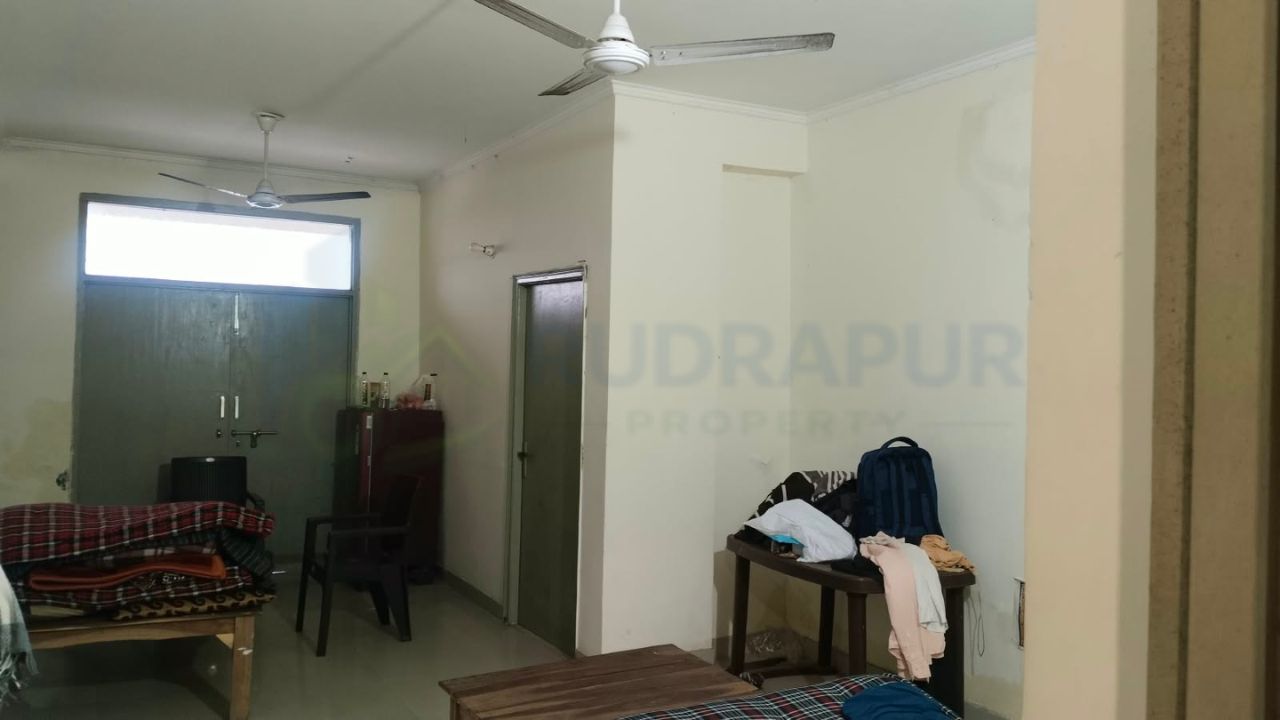 Living and dining area inside affordable 3 BHK flat in Danpur Rudrapur priced at 52 lakh
