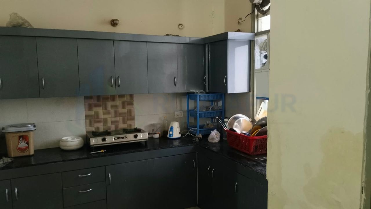 Modern kitchen with storage cabinets inside 3 BHK flat in Balaji Pranam Society Danpur Rudrapur