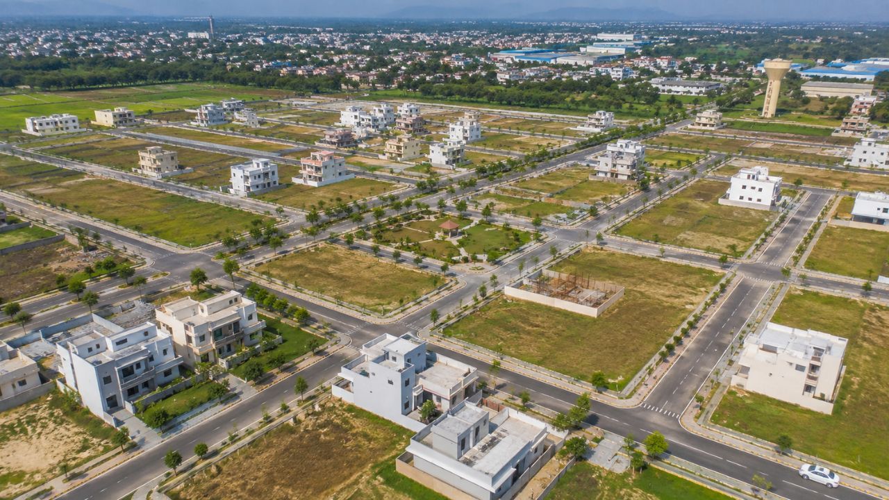 Aerial view of residential plots for sale in Rudrapur with developed roads, houses, and planned infrastructure